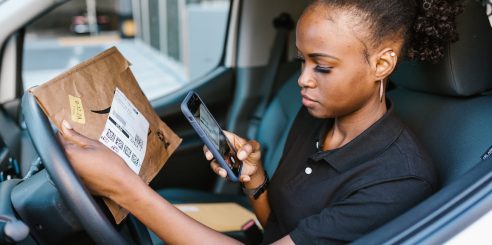 Woman Taking a Picture of a Parcel using shipping management software app