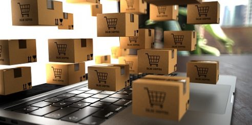 Small shipping packages on a notebook with the inscription Online Shopping. 3d illustration.